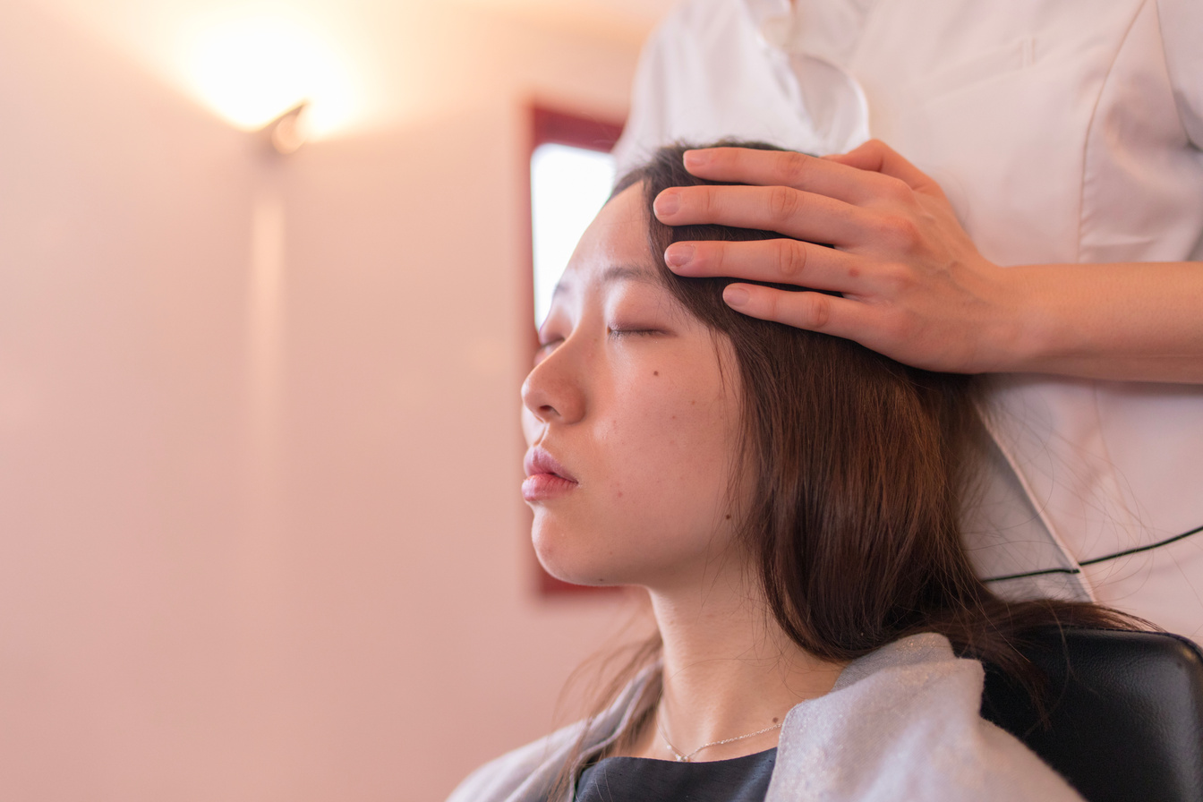 Beautiful woman receiving head massage